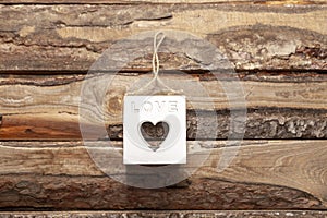 Valentine`s day love heart shaped cube decoration on rustic style wooden background with copy space. Holiday card for valentine`