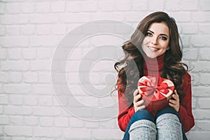 Valentine's Day. Lovely girl with a gift box heart.