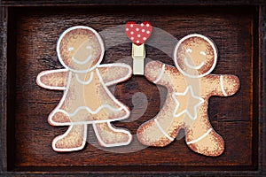 Valentine`s Day. Lovers gingerbread men holding red heart love symbol