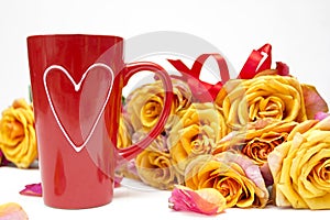Valentine`s day, mother`s day and women`s day concept. Bouquet of roses and red mug with heart