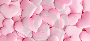 Valentine`s Day. Pink heart shape backdrop. Abstract holiday Valentine background with pink satin hearts. Love concept