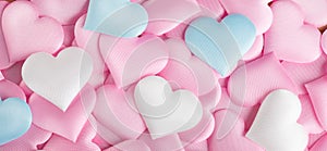 Valentine`s Day. Pink heart shape backdrop. Abstract Valentine background with pink, white and blue pastel color satin hearts