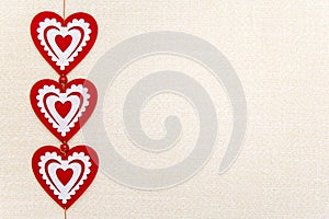 Valentine`s day, postcard, restaurant menu, natural linen background, burlap, Three red hearts with white ornament, high quality,