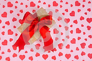 Valentine`s Day. Presented as a red ribbon on a pink paper with red hearts