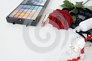 Female accessories, jewelry, perfume bottle, gift, pearls, red rose on a white background.