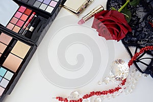 Female accessories, jewelry, perfume bottle, gift, pearls, red rose on a white background.