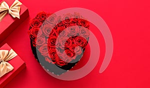 Valentine`s day. Red heart made of roses. Red ackground with Valentines gifts decor. Top view with copy space. Minimalism. Flower