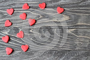 Valentine`s Day . Red hearts on a wooden background.