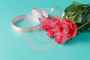 Valentine's Day: red roses and ribbons on aquamarine background