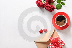 Valentine's day romantic coffee with gift, sweets, letter and red roses.