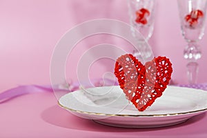 Valentine`s day romantic dinner with red hearts on pink background
