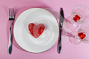 Valentine`s day romantic dinner with red hearts on pink background