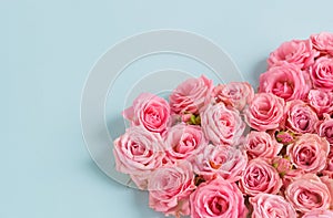 Valentine`s day romantic greeting card. Composition with a heart of pink roses on a blue background.Mothers day. 8 Marth