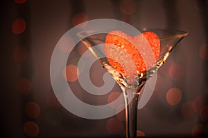 Valentine`s day, romantic still life with glass and heart, blurred background, bokeh effect, shallow depth of field