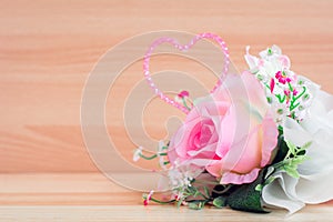 Valentine`s Day roses on wooden background