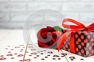 Valentine`s Day setting with red rose and Ð° gift box