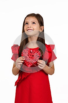 Valentine`s day. smiling child girl with red heart