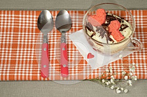 Valentine's Day tiramisu with chocolate in glass cup.