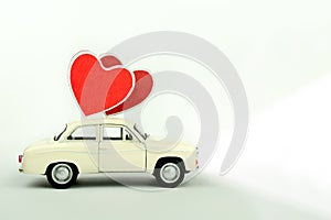 Valentine`s day, toy retro car with hearts  on white background