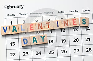 Valentine`s Day words arranged from wooden letters on the calendar. 14 February day of lovers