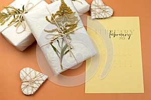 Valentine`s Day Zero Waste Concept. Eco-friendly craft paper packaging. Gift Box with a branch of a dried flower tied with jute.