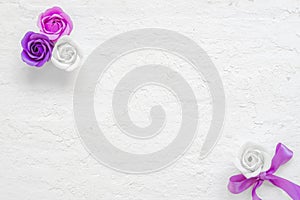 Valentine& x27;s flat lay mockup. Beautiful pink and violet rose flowers on grunge white wooden background with copy space. Styled