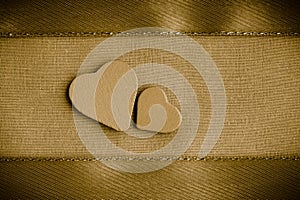 Valentine wooden decorative hearts on golden cloth background