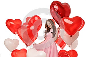 Valentine& x27;s day. Beauty girl holding red air balloons, symbols of love. Happy Young woman laughing. Model having fun
