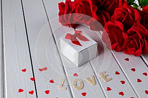 Valentines background with red rose, Heart shape, Gift box, Wooden letters word