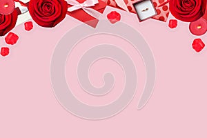 Valentines background with red rose, valentine envelope and petals on pink, flat lay with copy space, top border