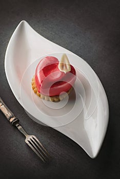 Valentines cake with heart shape with metal fork on black backgrount, produkt photography for patisserie