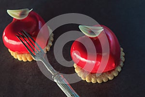 Valentines cake with heart shape with metal fork on black backgrount, produkt photography for patisserie