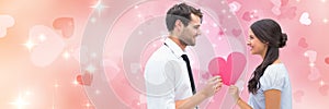 Valentines couple holding heart with love hearts background