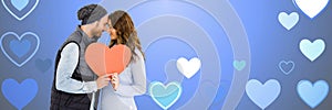 Valentines couple holding heart with love hearts background