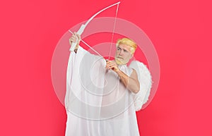Valentines day angel. Handsome cupid aiming up with bow and arrow. God of love. February 14.