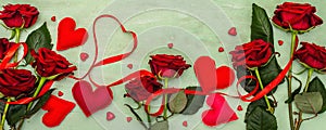 Valentines Day background with assorted hearts, fresh burgundy roses and red festive ribbon