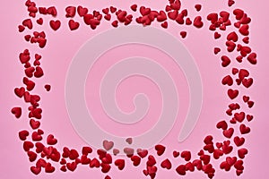 Valentines Day background. Border of red hearts on pink background. Copy space, top view