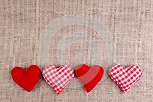 Valentines Day background with fabric hearts on sackcloth, copy