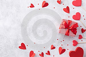 Valentines day background with gift or present box and various red hearts. Flat lay greeting card