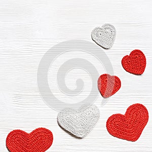 Valentines day background, knit hearts valentine, handmade red crochet heart on white wood table, handmade gift for