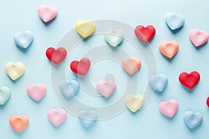 Valentines Day background with many small paper hearts in pastel colors