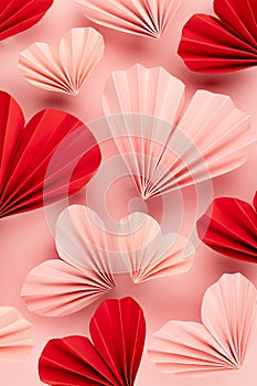 Valentines day background - mix of pink and red paper ribbed hearts fly on soft light pastel pink color as hearts abstract pattern