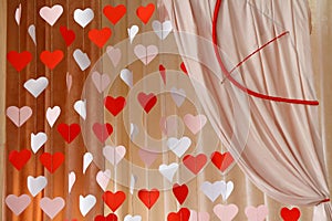 Valentines Day background with paper hearts. The red and white heart shapes on wooden arch background in love