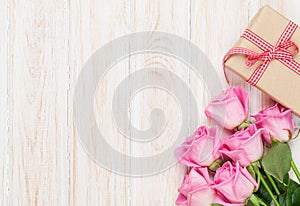 Valentines day background with pink roses and gift box