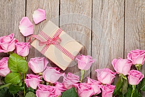 Valentines day background with pink roses over wooden table and