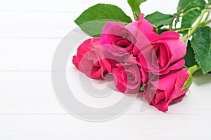 Valentines day background with pink roses on wooden table