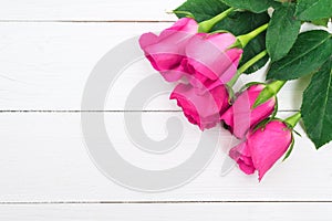 Valentines day background with pink roses on wooden table