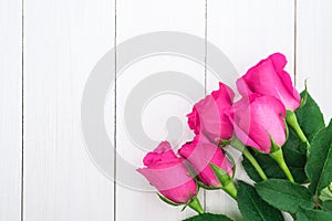 Valentines day background with pink roses on wooden table