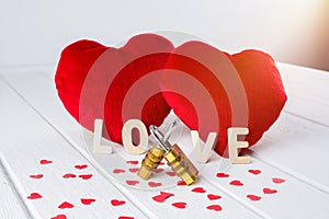 Valentines Day background with Red Heart shape and Couple Combination golden padlock on white wooden table