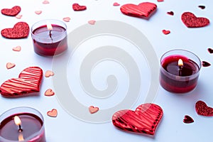 Valentines day background: red love hearts, romantic gift box, candle on white table. February romance present card
